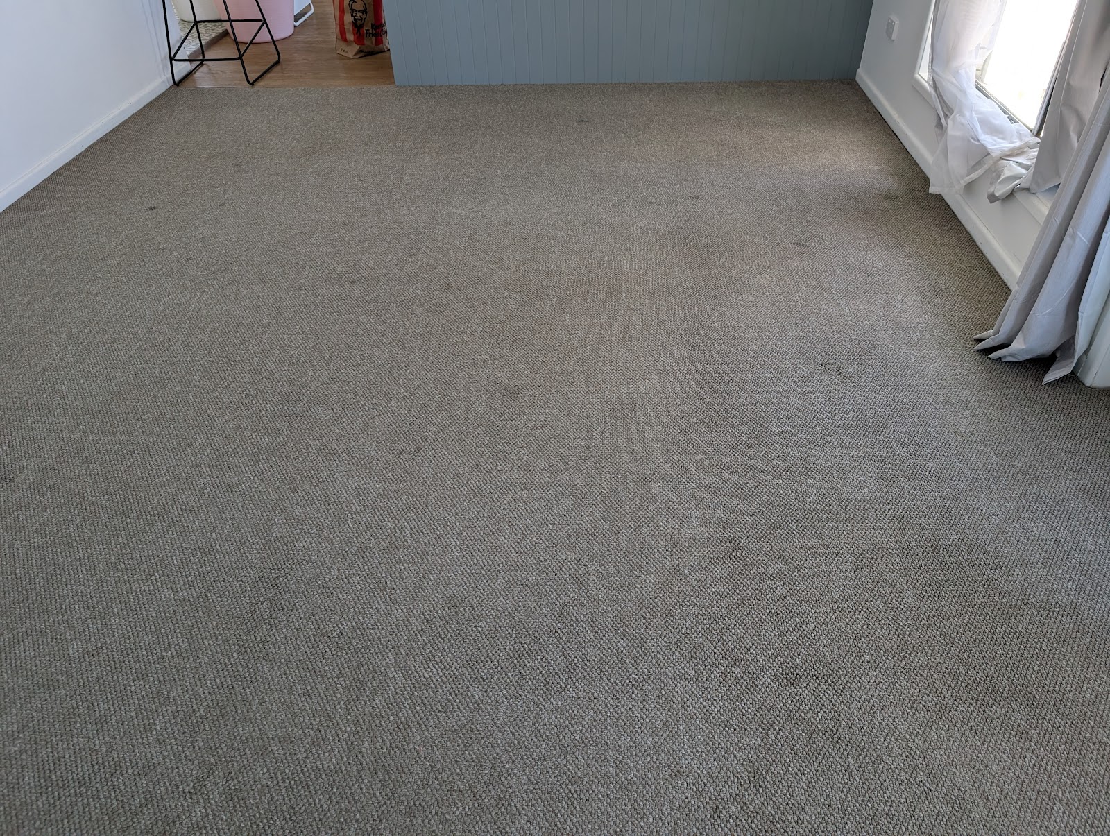 Grey carpet with visible marks before cleaning
