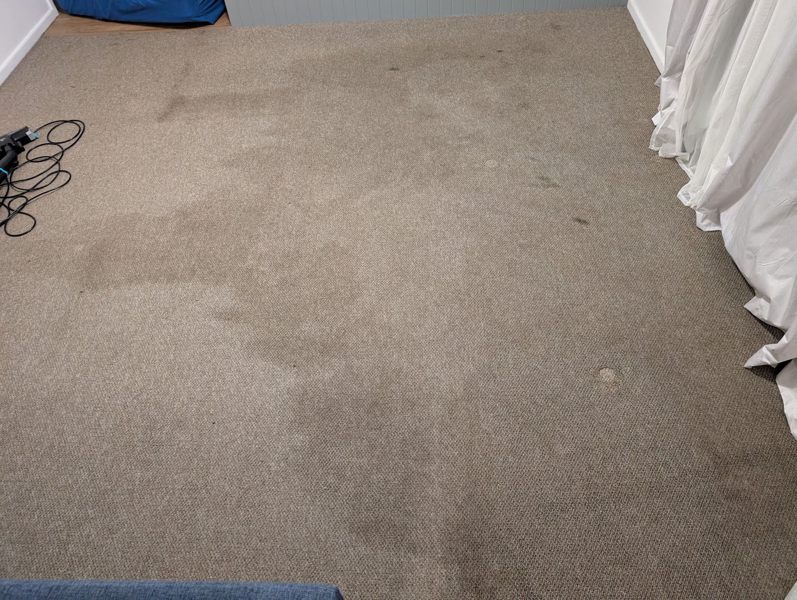Beige carpet with heavy dark staining before cleaning
