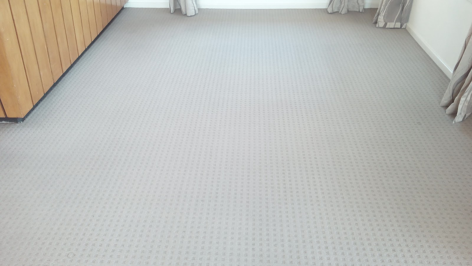 Clean grey carpet beside timber panelling